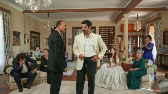 Two men in formal wear face off in an opulent living room as others in evening gowns watch from sofas and chairs.